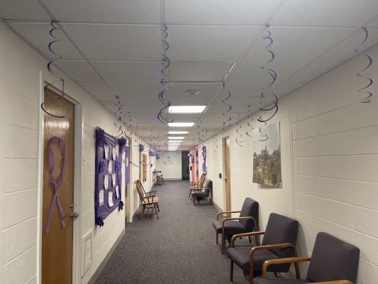 hallway with chairs and purple decorations