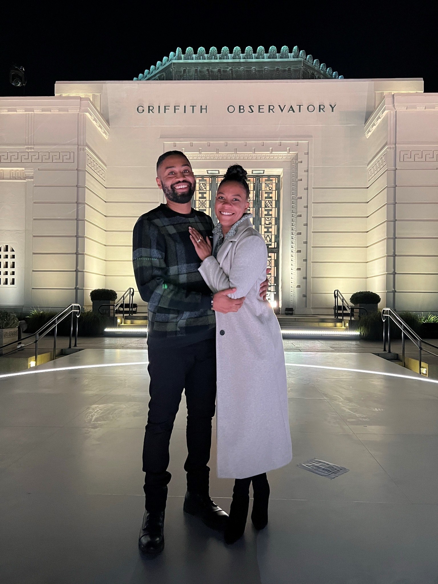 couple hugging in front of Griffith Observatory