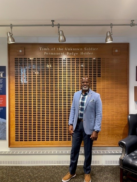 Bart Womack in front of wall with plaques