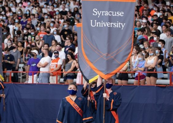 senior class marshals holding a Syracuse University banner at Class of 2022 Convocation