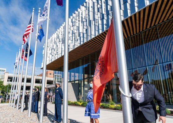 various flags fly outside of the National Veterans Resource Center at the Daniel and Gayle D’Aniello Building