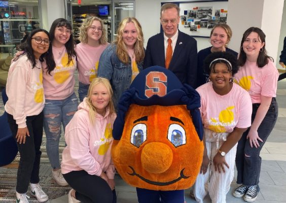 Chancellor Syverud poses with Otto and members of the Mandarins a capella group during the 2022 National Orange Day Celebration