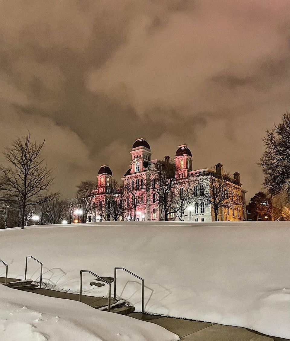 Hall of Languages at night with snow covered ground in foreground