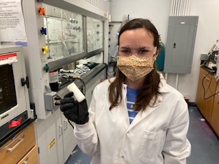 professor holds lab material