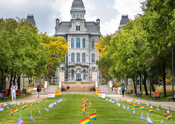 Hall of Languages exterior with small rainbow flags on lawn in front