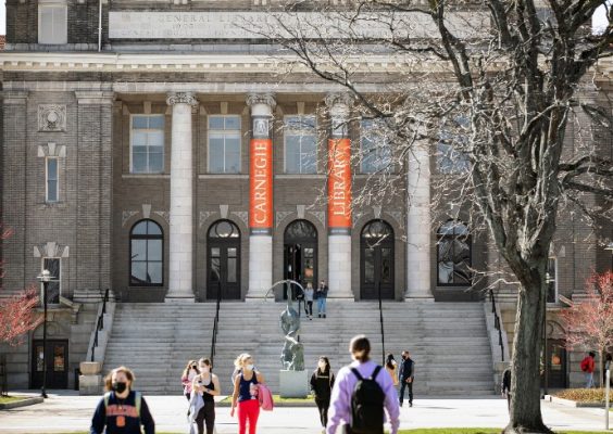 students walking outside of Carnegie Library on a spring day
