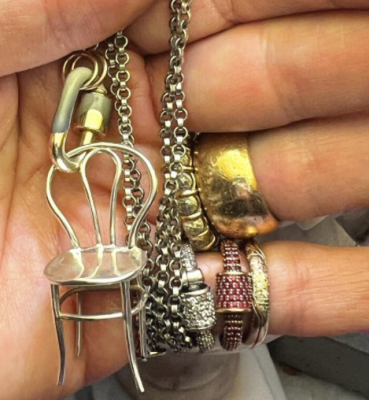 several pieces of jewelry draped on a hand