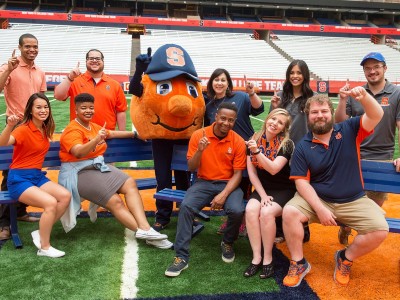 Otto posing with students and staff members