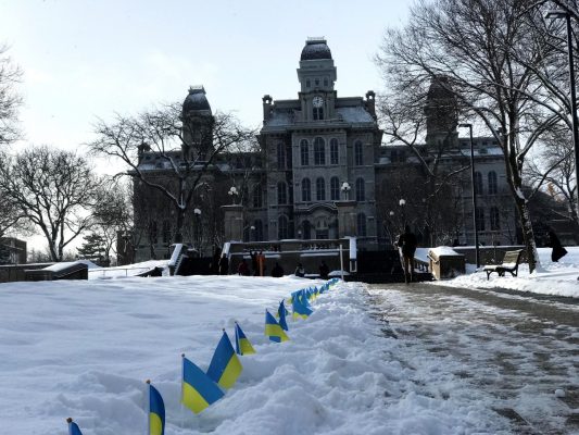 small Ukrainian flags posted in the snow leading up the Hall of Languages in February 2020