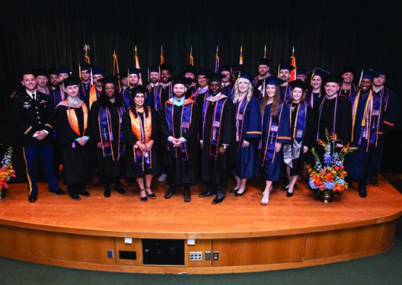 graduating students standing on stage