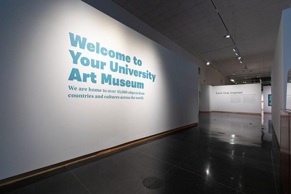 interior view of Syracuse University Art Museum with decal on the wall that says "Welcome to Your University Art Museum. We are home to over 45,000 objects from countries and cultures around the world."