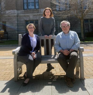 Melissa Welshans, Jolynn Parker and Adam Crowley, staff members in the Center for Fellowship and Scholarship Advising, gather on a bench outside Bowne Hall