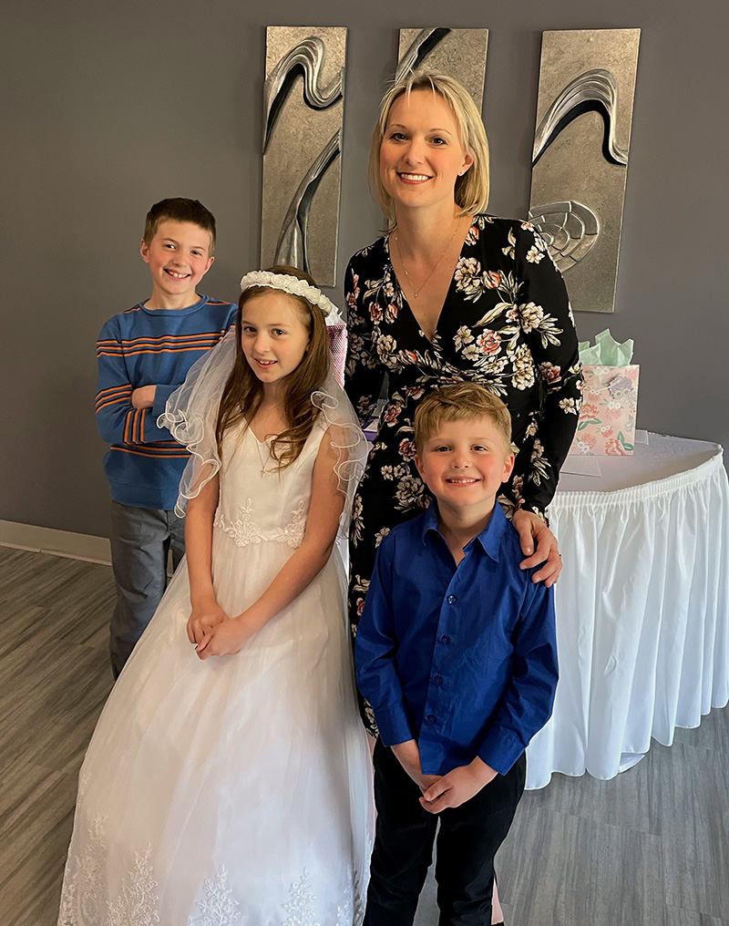Carrie Prue with children Christian, Kayla and Brady during a first communion celebration