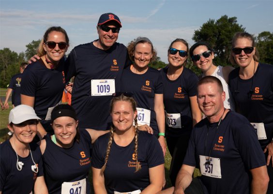 group of faculty and staff pose together at the Syracuse Workforce Run