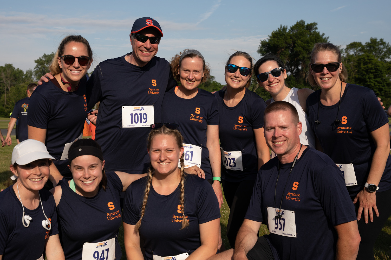 a group of faculty and staff pose together at the Syracuse Workforce Run