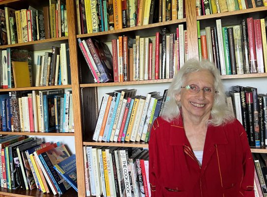 Gretel Pelto in front of cookbook collection