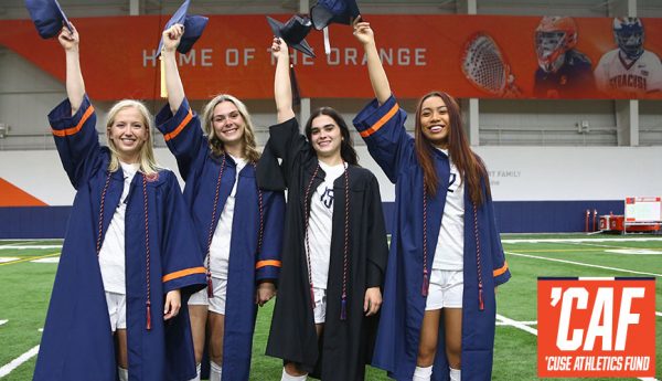 four student athletes in cap and gown