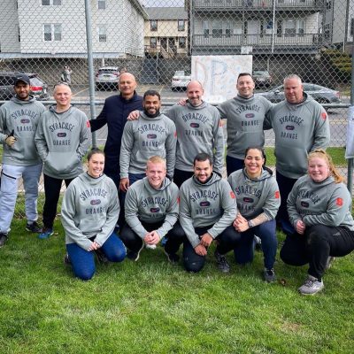 group of Syracuse University employees at a kickball game with students