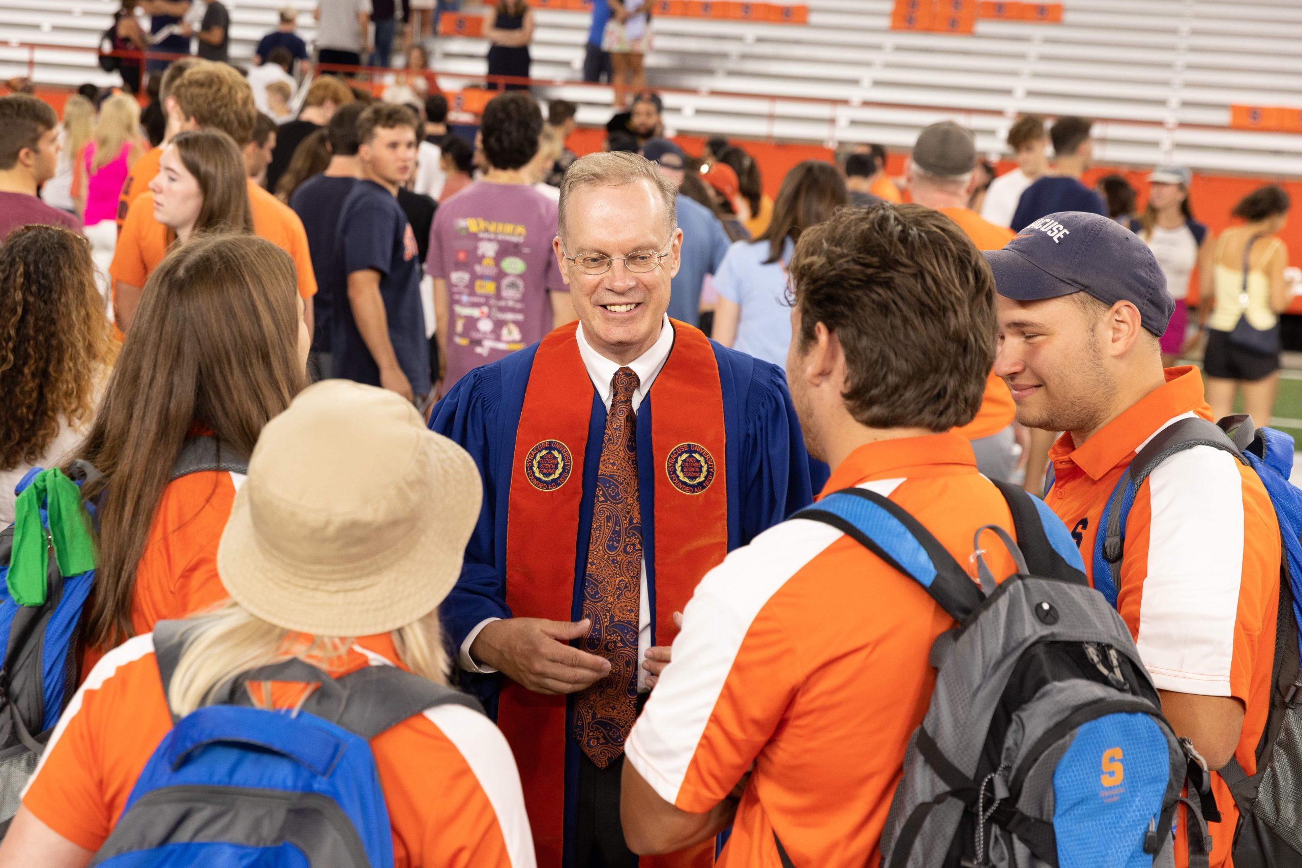 Chancellor Kent Syverud mingles with a group of students in the JMA Wireless Dome during New Student Convocation
