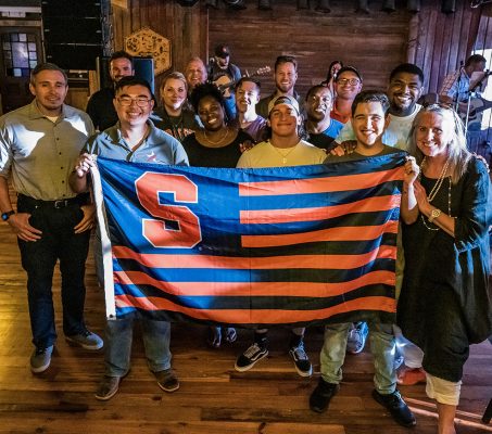 people posing with SU flag