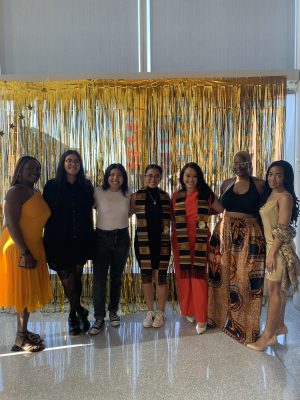 Breana Nieves Vergara posing with several of her student mentors and mentees in her role as coordinator of mentoring programs in Multicultural Affairs.