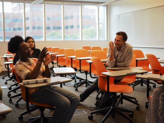Professor Brice Nordquist collaborates with two students in a classroom environment during the Narration Fellowship summer workshop