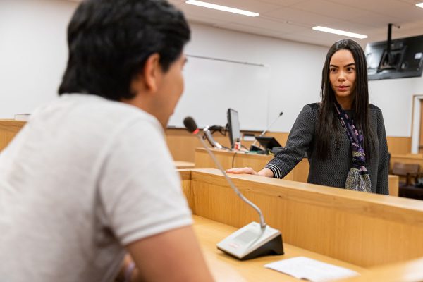 one student in the English for Lawyers program questions another during a mock trial