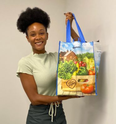 person holding up grocery bag