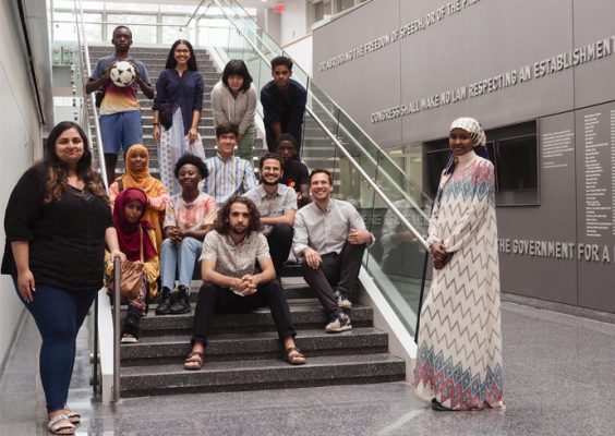 2022 Syracuse Narratio Fellowship cohort gathers together on the stairs in the Newhouse School