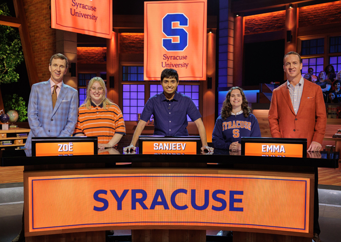Syracuse University students standing on the set of the NBC's College Bowl.