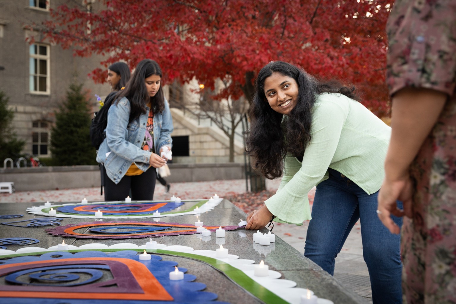 students light candles during the Diwali 2022: Light Up the Orange Grove celebration