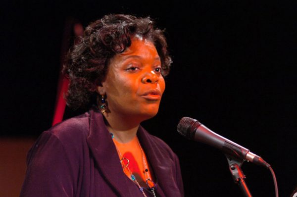Carol Charles speaking in microphone