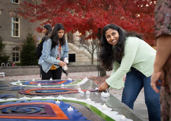 students light candles during the Diwali 2022: Light Up the Orange Grove celebration