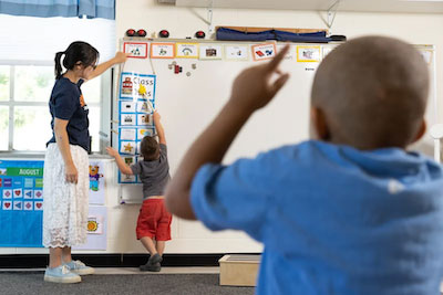 Emily Liu teaching at a whiteboard