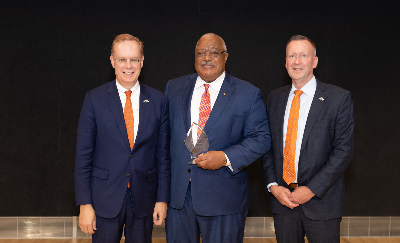 Chancellor Syverud, Melvin Stith G'73, Ph.D.'78, and Mike Haynie pose during Orange Central