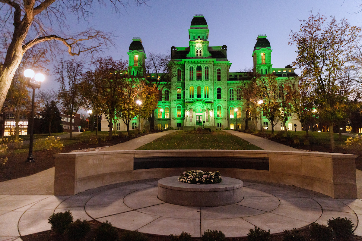 Hall of Languages building lit up in green light for Veterans Day 2022