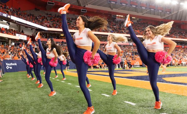 Cheerleaders and dance team members perform during Orange Central football game.