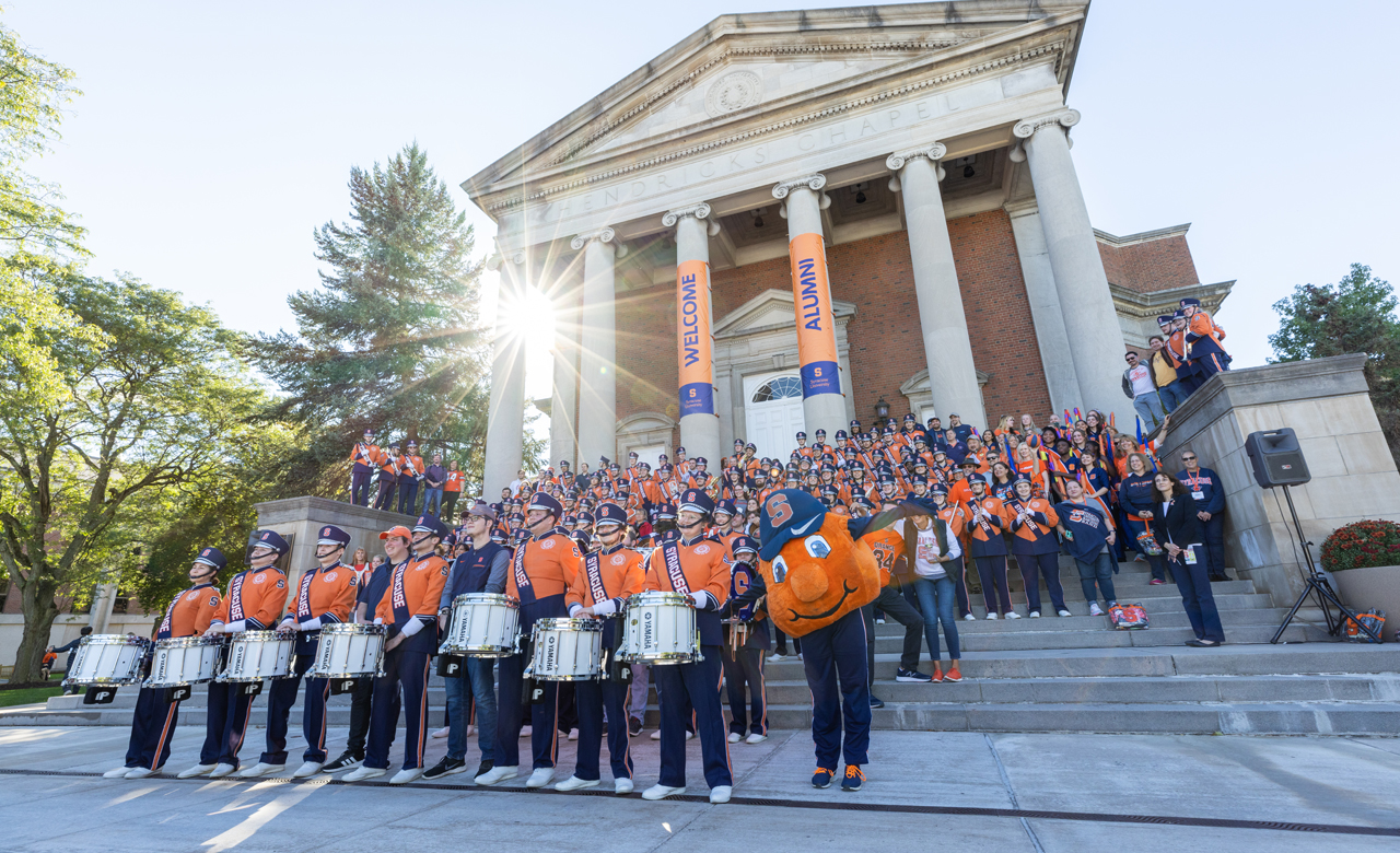 Syracuse University Marching Band members in front of the steps of Hendricks Chapel.
