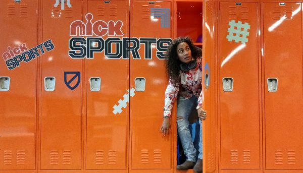 Janina Rios peeks out of a locker during her internship with Nick Jr.
