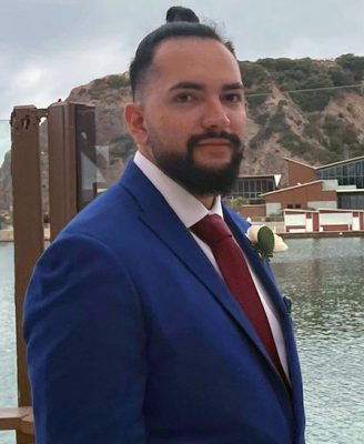 Portrait of Jose Beza-Ruiz in front of the water