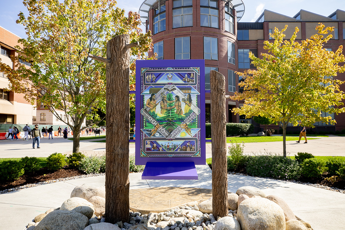 the painting “Gayaneñhsä•ʔgo•nah" which is dedicated to Haudenosaunee cultures, origins and influence, is affixed to two white pine logs on Shaw Quadrangle