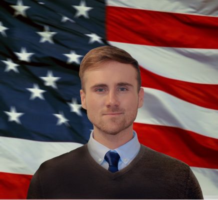 headshot of Ryan Yon in front of an American flag