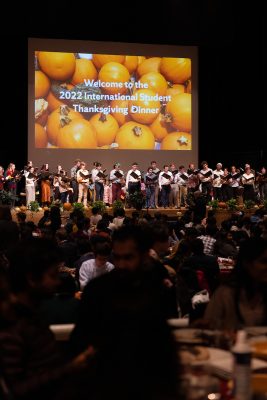 Group of singers on stage performing for audience at International student Thanksgiving