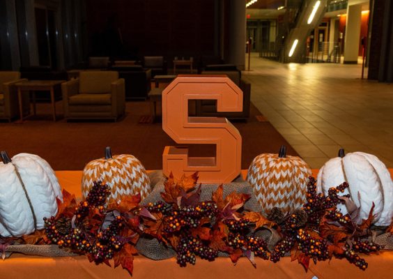 harvest decor and a Block S on display at the International Thanksgiving Celebration