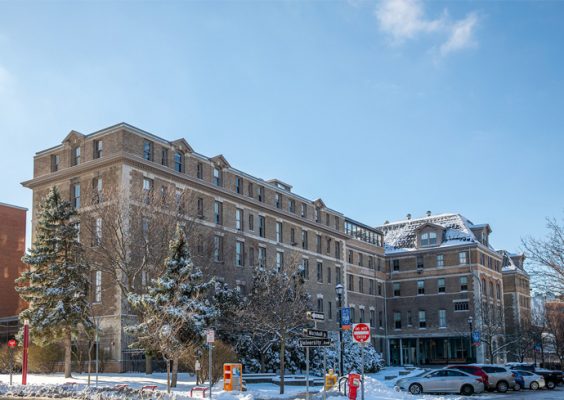 exterior view of Huntington Hall with a light dusting of snow