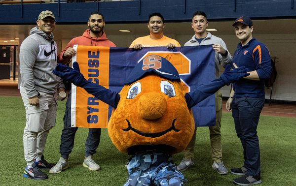Student Veterans Organization members pose with Otto and a Syracuse flag at the Nov. 12 football game