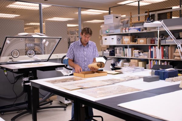 person going through paperwork on top of desk