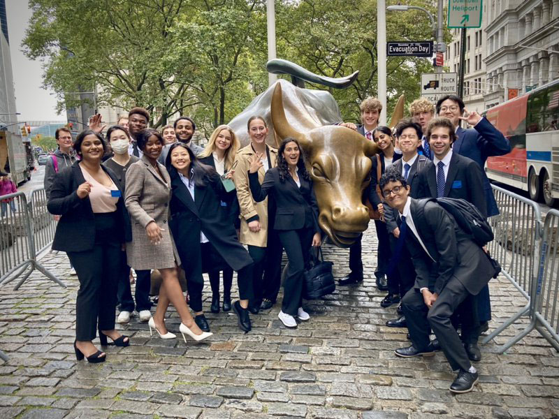 students posing on Wall St. in New York City