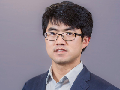 Professional headshot of a man smiling.