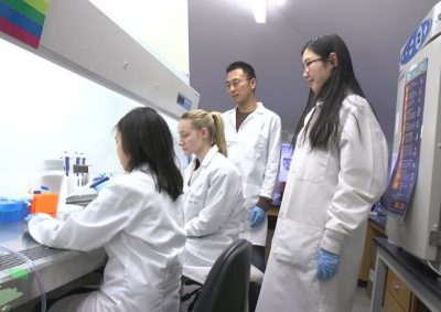 professor and students in a science lab
